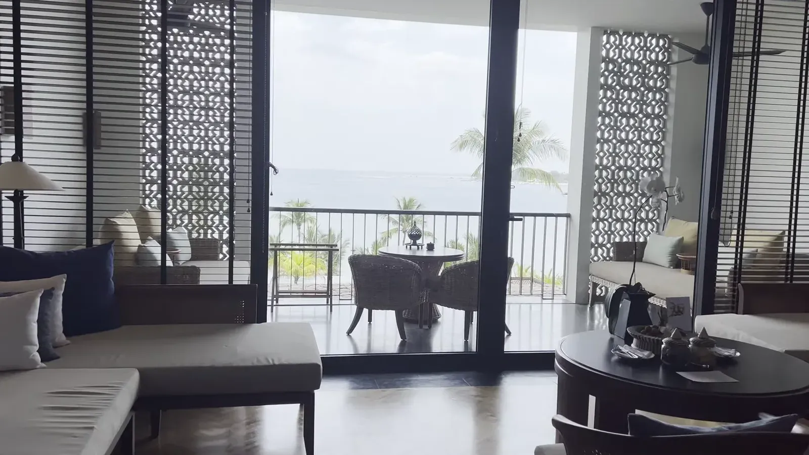 The living area of the Ocean View 1-Bedroom King Suite at The Sira Lombok, looking out to the balcony and sea